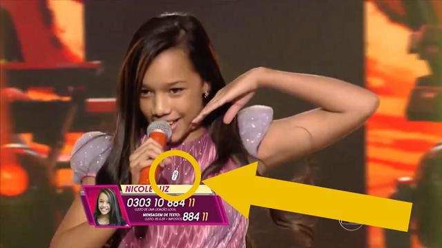 Nicole Luz wears her Young Women pendant while singing on The Voice Brazil